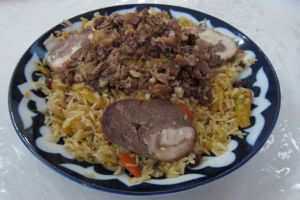 Plov adorned with kazy (horse meat sausage)